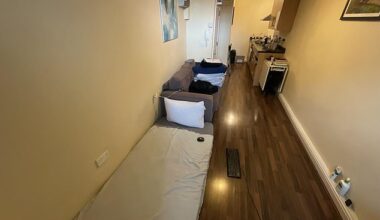 The studio-style home is essentially one long, narrow room with a single mattress laid out on the floor next to a sofa