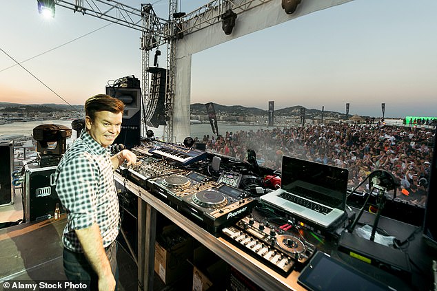 Double decker: DJ Paul Oakenfold keeping a crowd of thousands dancing in Ibiza in 2012