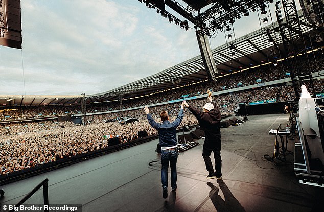 The Gallagher brothers are pictured putting on a united display as they took to the stage in Edinburgh