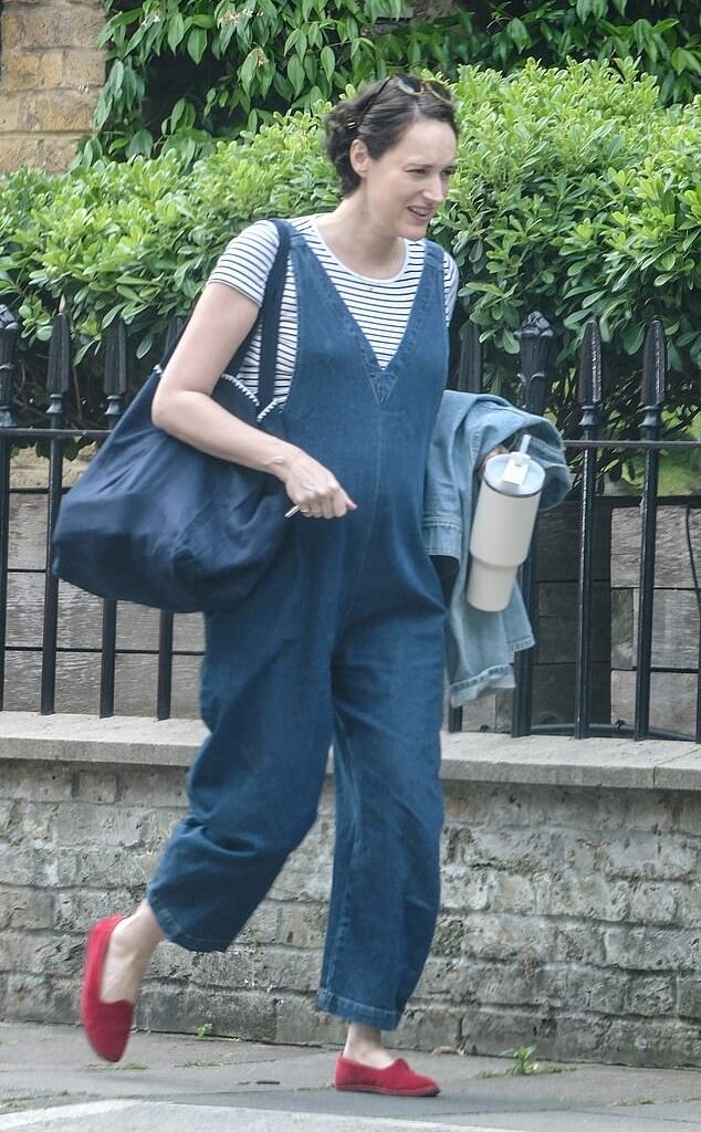 Phoebe Waller-Bridge, 40, was spotted in north London carrying a large tote bag while she showed off her blossoming bump in a pair of denim dungarees and striped T-shirt
