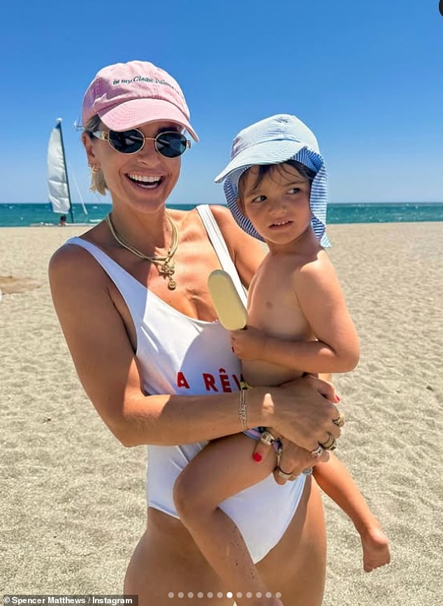 The Irish presenter, 39, slipped into a white swimsuit and pink baseball cap as she hit the beach and carried their youngest child Otto, three