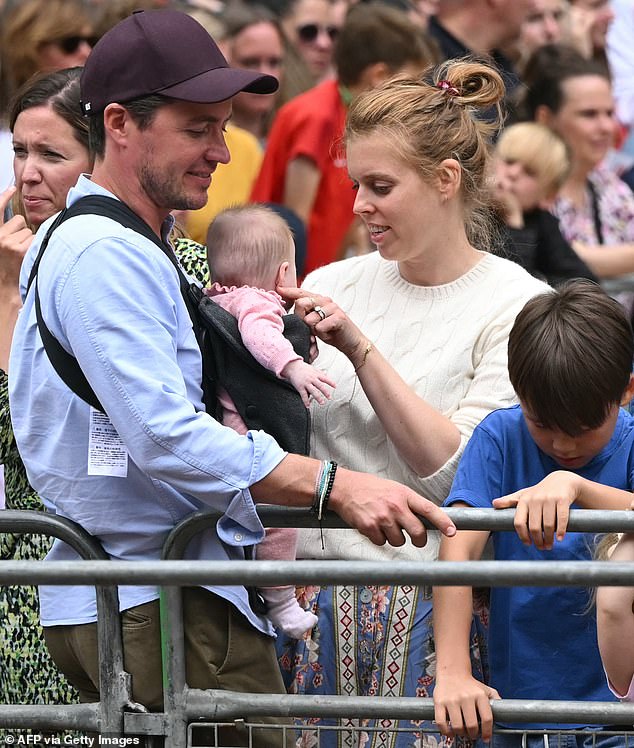 Princess Beatrice her husband Edoardo Mozzi (CL) and children Sienna, Athena and Christopher joins fans lining the Mall waiting to greet the bus carrying the England women's national football team during the homecoming victory parade near Buckingham Palace in London on July 29, 2025