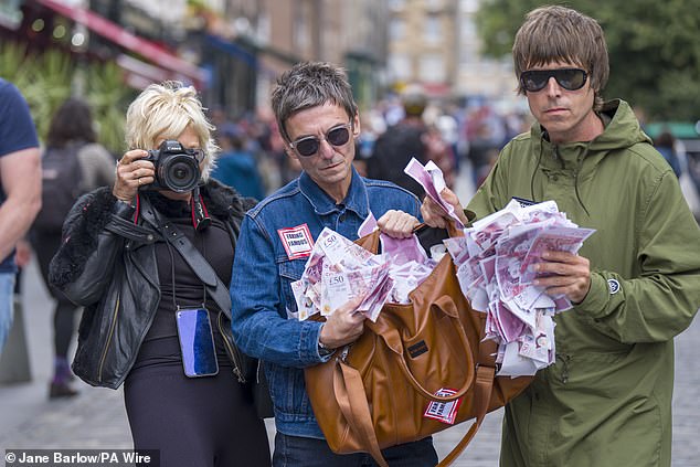 Lookalikes of Liam and Noel Gallagher get into character, with artist Alison Jackson, in The Grassmarket, Edinburgh, to promote the Edinburgh Fringe Festival show