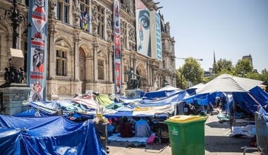 Migrants in a makeshift camp in front of the Paris City Hall wait for emergency accommodation in Paris, France, 11 August 2025