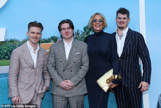 Stone was pictured with her three adoptive sons (L-R) Roan, 25, Quinn, 19, and Laird, 20