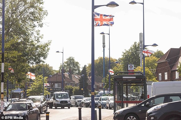 A group of 'proud English men' have defiantly hit back at accusations they are racist after lining their streets with Union Jack flags. Pictured: Union Jack and St George's flags in Weoley Castle