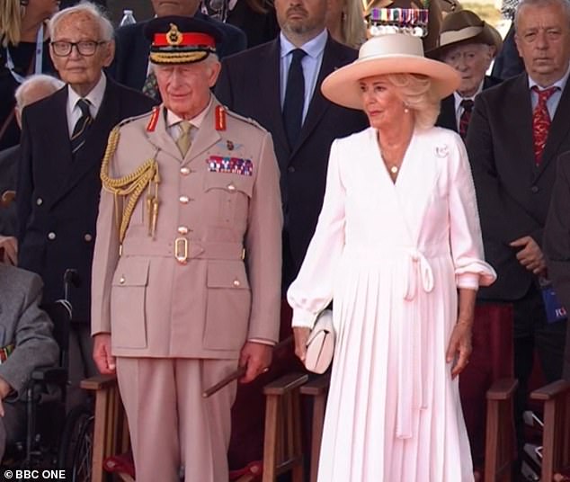 Her Majesty was wearing a white pleated chiffon dress by Dior and a white Philip Treacy hat while the King wore The Stone Field Marshal Number 4 uniform