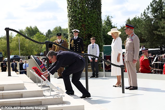Prime Minister Keir Starmer (L) lays a wreath during a national service of remembrance at the National Memorial Arboretum in Alrewas