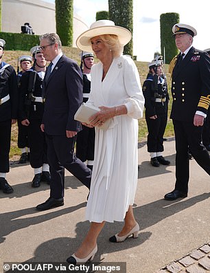 Her Majesty was wearing a white pleated chiffon dress by Dior and a white Philip Treacy hat