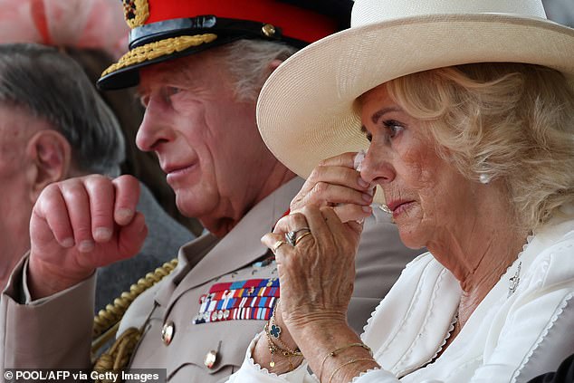 The Queen was seen bringing a tissue to her eye during the moving service