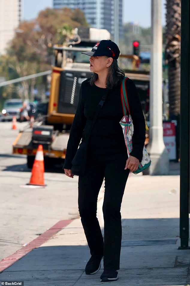 The 66-year-old Singapore-born actress, Julia Nickson was seen in a sleek, all-black outfit - long-sleeve top, flared leggings, sneakers, and a baseball cap - as she ran errands near her Los Angeles home, weaving through a street busy with construction crews