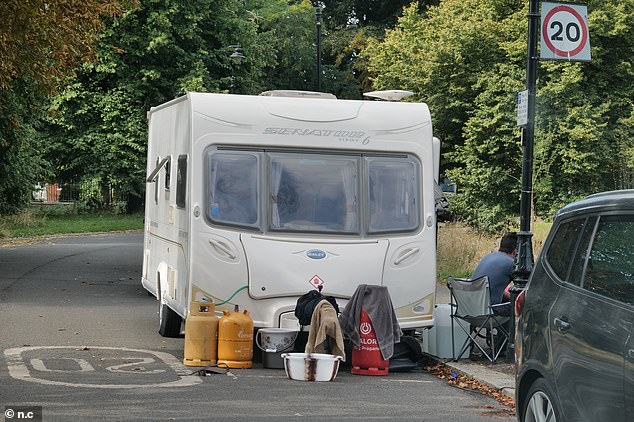 The group appear to have made themselves quite at home, with fold-out tables, towels and gas cylinders dotted around the temporary camp