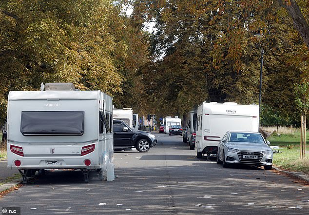 Several caravans can be seen parked along Warwick Road, which runs through the heart of Ealing Common