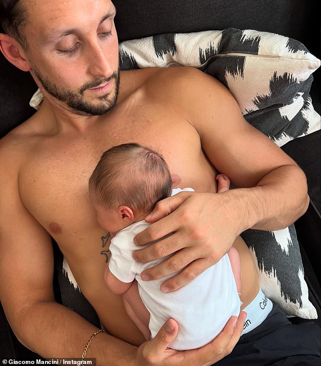 The tot, dressed in a pink cardigan, was seen in her Moses basket and sleeping on her father's bare chest