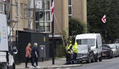 Tower Hamlets council workers pull down a St George's Cross put up by patriotic campaigners