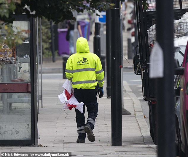 One of the workers walking away with one of the flags this morning