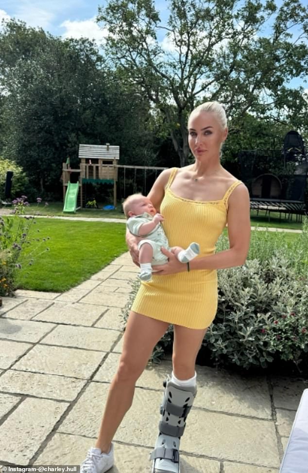 She also shared a photo of herself wearing the boot while holding a baby