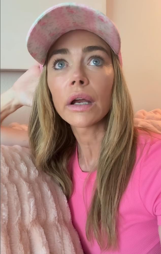 The former Bond girl shared a video to Instagram where she was wearing a bright pink top and light mink cap as she sat on a sofa