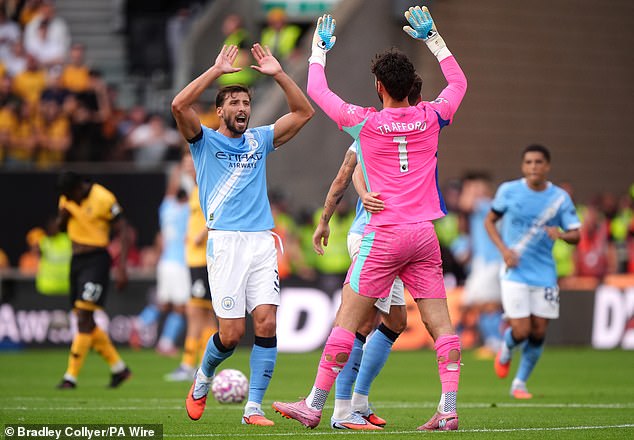 Dias, celebrating with goalkeeper James Trafford at Wolves, is seen as a future captain at City