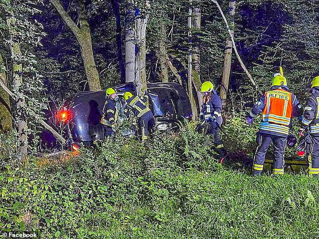 A man and three women - thought to be two married couples - died when the driver failed to navigate a left-hand bend in northern Hesse. Pictured: Emergency responders at the scene