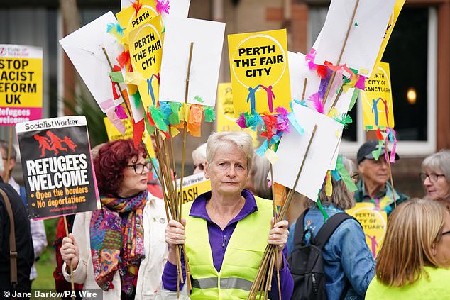 People take part in a counter protest against an Abolish Asylum System protest outside the Radisson Hotel in Perth on Saturday