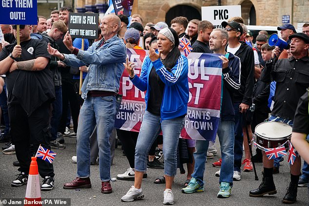 Many protesters held signs reading 'get them out' and 'Perth is full' at a protest outside the Radisson Hotel
