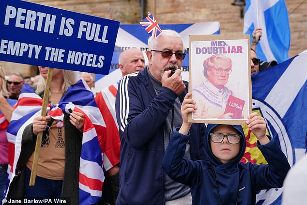 People demonstrating at an Abolish Asylum System protest outside the Radisson Hotel in Perth on Saturday morning