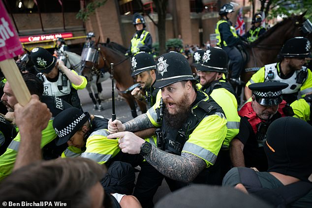 Mounted police officers scuffle with demonstrators during a protest by Abolish Asylum System and counter protesters at Castle Park in Bristol
