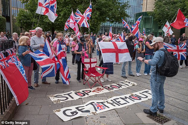 A sign on the floor reads 'stop the boats get them out' in Newcastle