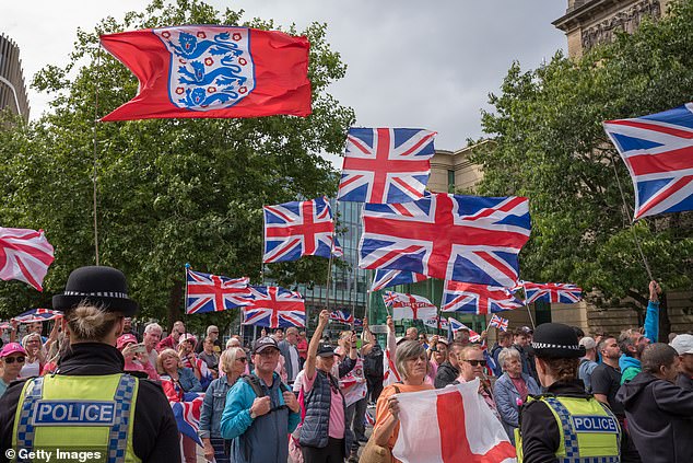 A crowd of anti-immigration protesters waving Union Jacks and England flags outside the New Bridge Hotel in Newcastle