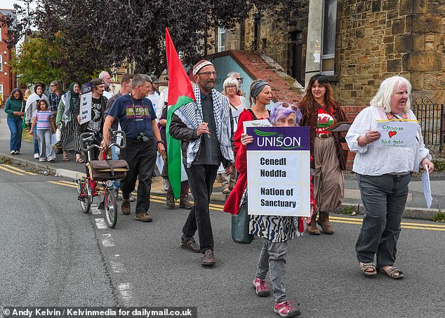 Counter protesters arrive to confront the anti-immigration protest in Mold, Wales