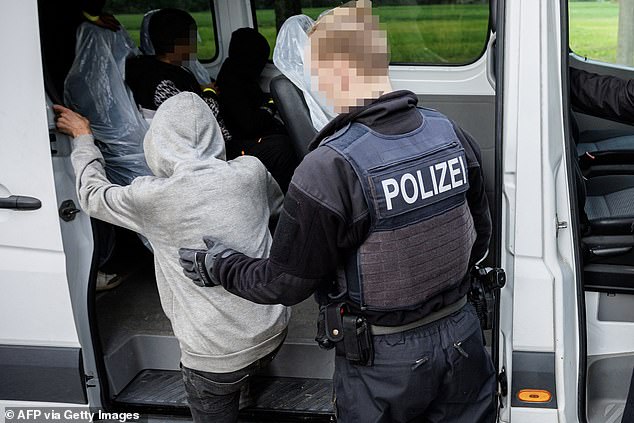 Migrants get into a German Federal Police (Bundespolizei) vehicle, near Forst, eastern Germany on October 11, 2023, after a patrol at the border with Poland