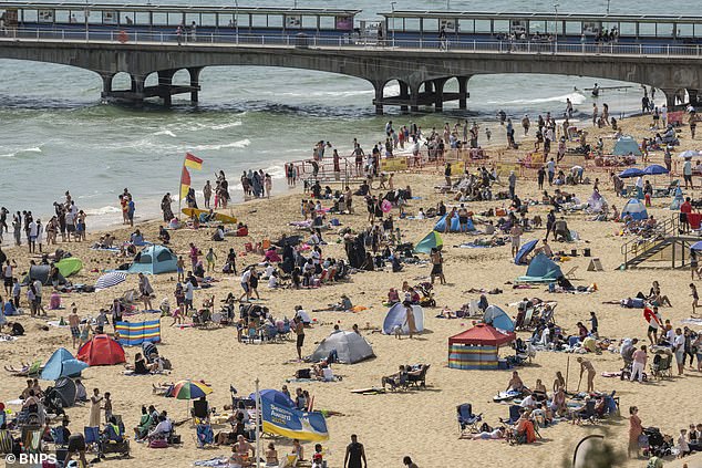 Thousands of people pack the beach in Bournemouth on Sunday as holidaymakers enjoy the scorching sunshine and cloudless blue skies in Dorset