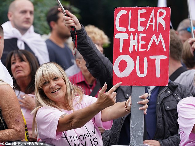 People demonstrating under the Abolish Asylum System slogan outside the former Bell Hotel in Epping on Sunday