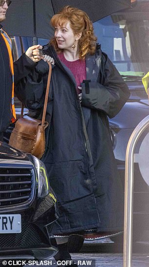 During a break in filming Katherine slipped on a dry robe and popped her feet into comfy sandals