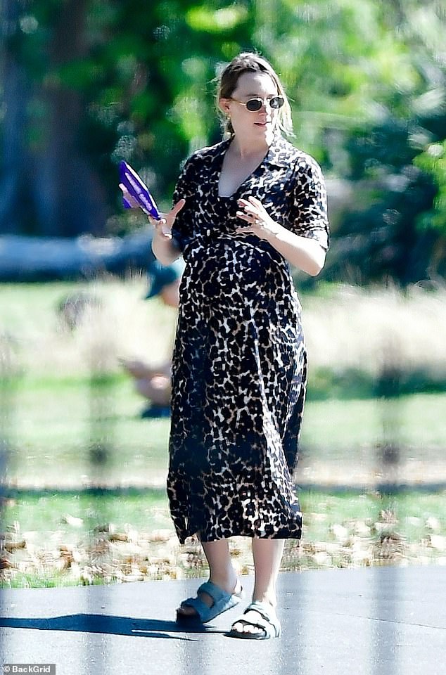 It looked as though Saoirse was cooling off in the hot weather as she tucked into a Dairy Milk ice-cream during their walk in the sun