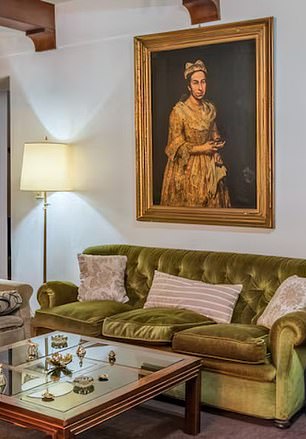'Portrait of a Lady was pictured hanging over a sofa in a real estate listing posted by Robles Casas & Campos