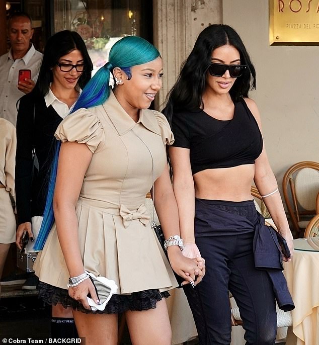 Kim and North put on an affectionate display by holding hands while making their rounds