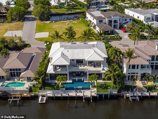 The posh pad ¿ complete with a waterfall-edge pool, spa, home cinema and private dock ¿ is located in the exclusive Royal Palm Yacht & Country Club in Boca Raton