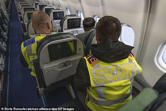 Officers from the German Federal Police and the European border protection agency Frontex pictured on a plane with a man being deported in February