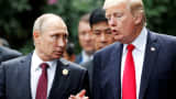 FILE PHOTO: U.S. President Donald Trump and Russia's President Vladimir Putin talk during the family photo session at the APEC Summit in Danang, Vietnam November 11, 2017. 