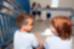 School children talking in school building stairway