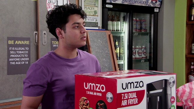 Aadi in the shop in Corrie