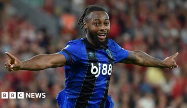 Semenyo celebrating after scoring for Bournemouth. He had short dreadlocked hair and a dark brown beard. He was wearing his dark blue and black Bournemouth away kit.