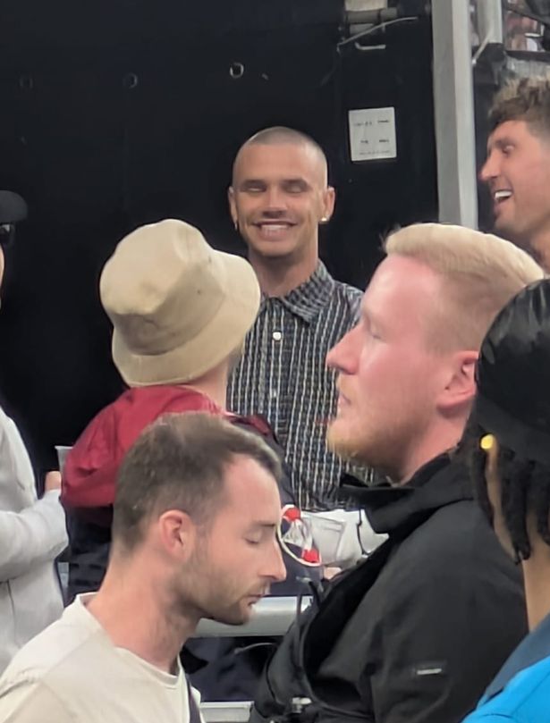 Romeo Beckham in a VIP area of Wembley Stadium with footballer John Stones.