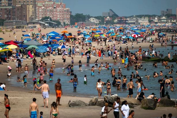 People try to stay cool at the beach