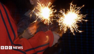 Children holding sparklers - their faces cannot be seen