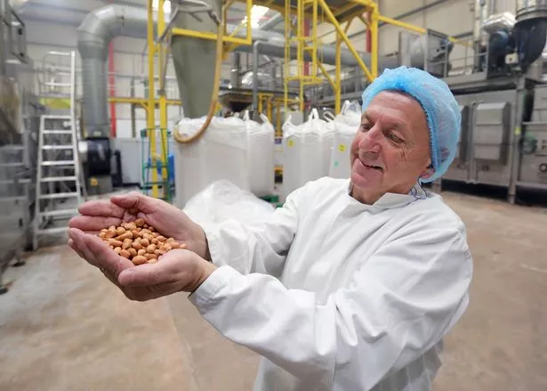 The image shows Chris proudly showing off some peanuts