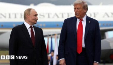 Donald Trump and Vladimir Putin stand side by side and speak as they pose for photos after their arrival for the US-Russia summit