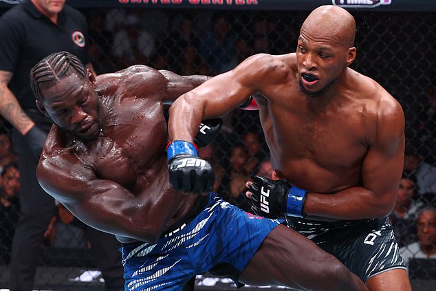 CHICAGO, ILLINOIS - AUGUST 16: (R-L) Michael Page of England punches Jared Cannonier in a middleweight fight during the UFC 319 event at the United Center on August 16, 2025 in Chicago, Illinois. (Photo by Ed Mulholland/Zuffa LLC)